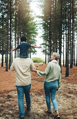 Buy stock photo Family, grandparents and walking with child in a forest for happy, health and love together. Care, love and woods with elderly couple and kid in nature for bonding, smile and happiness in autumn 