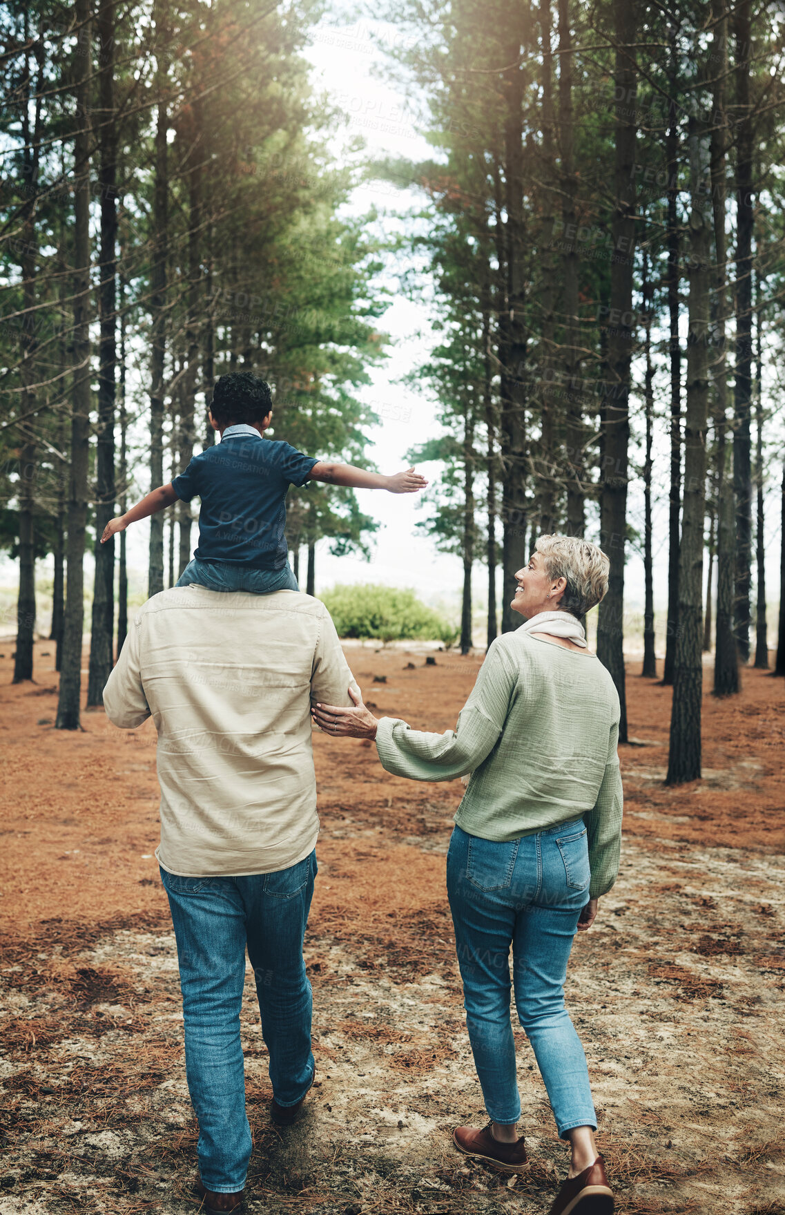 Buy stock photo Family, grandparents and walking with child in a forest for happy, health and love together. Care, love and woods with elderly couple and kid in nature for bonding, smile and happiness in autumn 