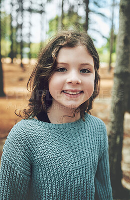 Buy stock photo Nature, happiness and portrait of child in forest with smile on face enjoy hiking trail in woods. Freedom, adventure and trees, happy young girl smiling on holiday hike or fun walking in outdoor park