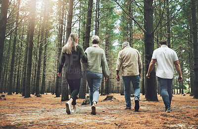 Buy stock photo Family, friends and forest adventure with parents and adult children walking in nature for outdoor hiking, fun and trees on wellness vacation. Running, couple and travel men and women in woods