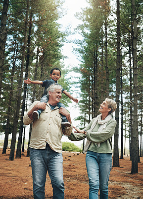 Buy stock photo Hike, nature and children with senior foster parents and their adopted son walking on a sand path through the tress. Family, hiking and kids with an elderly man, woman and boy taking a walk outside