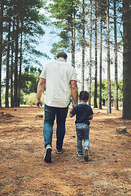 Buy stock photo Grandfather, child and hold hands for walk in forest, nature or woods together for bonding. Man and kid by trees, sunshine and summer for walking, fun and happiness on vacation with family
