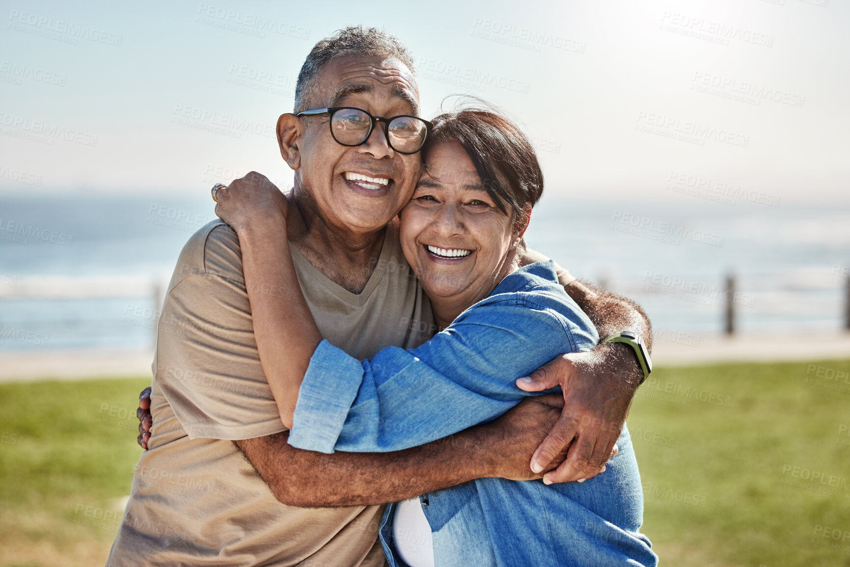 Buy stock photo Senior couple, hug and happy on vacation being romantic, smile or bonding to celebrate marriage, anniversary or beach. Elderly man, mature woman or embrace for relationship, relax or romantic travel 