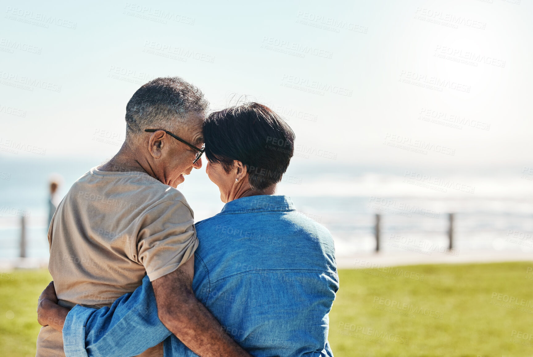 Buy stock photo Hug, love and senior couple at the beach for a holiday in Brazil during retirement in summer. Back of a relax, happy and elderly man and woman hugging with affection on a travel vacation by the sea