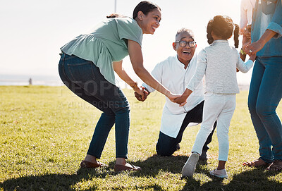 Buy stock photo Senior man, child and mother being outdoor, play and have fun while on seaside holiday, vacation and travel in summer. Mama, daughter and on field holding hands in circle, smile and happy together.