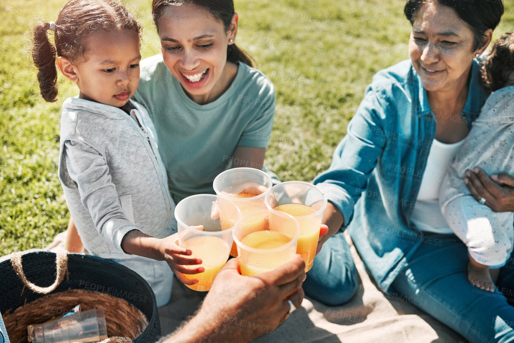 Buy stock photo Picnic, park and happy family cheers with juice, bonding and  enjoy fun quality time together. Mama love, happiness and freedom for relax grandma, mother and children drinking on nature grass field