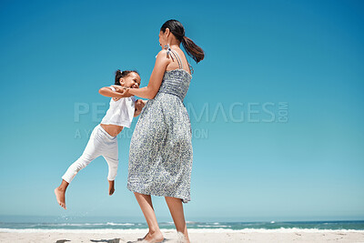Buy stock photo Mother, swing and girl at beach in summer for play, comedy and bonding on vacation, holiday or trip. Mom, child and ocean with smile, happiness and love by sea in sunshine, together and playful time