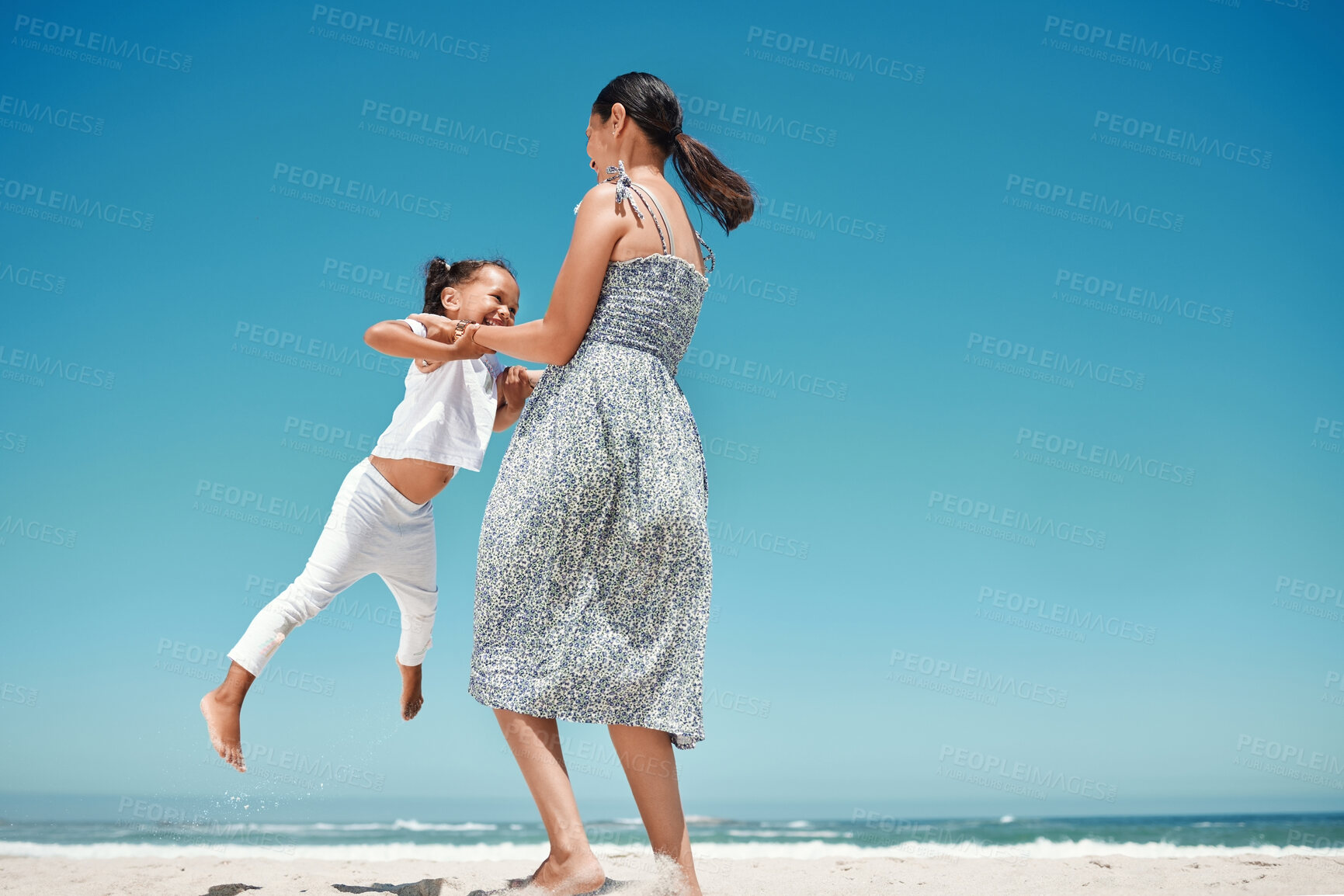 Buy stock photo Mother, swing and girl at beach in summer for play, comedy and bonding on vacation, holiday or trip. Mom, child and ocean with smile, happiness and love by sea in sunshine, together and playful time