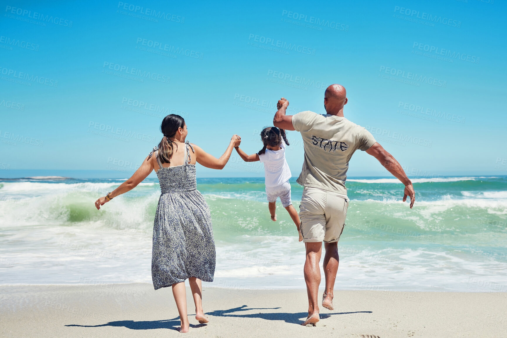 Buy stock photo Beach, holding hands and family lifting child in the air, having fun, playing and enjoying the waves. Travel, summer and love on vacation with mom, dad and young girl together by the ocean on holiday