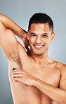 Man shaving armpit body hair for self care, hygiene and beauty skincare routine, wellness and epilation cleaning. Happy, smile and mockup portrait of young person grooming isolated on gray background