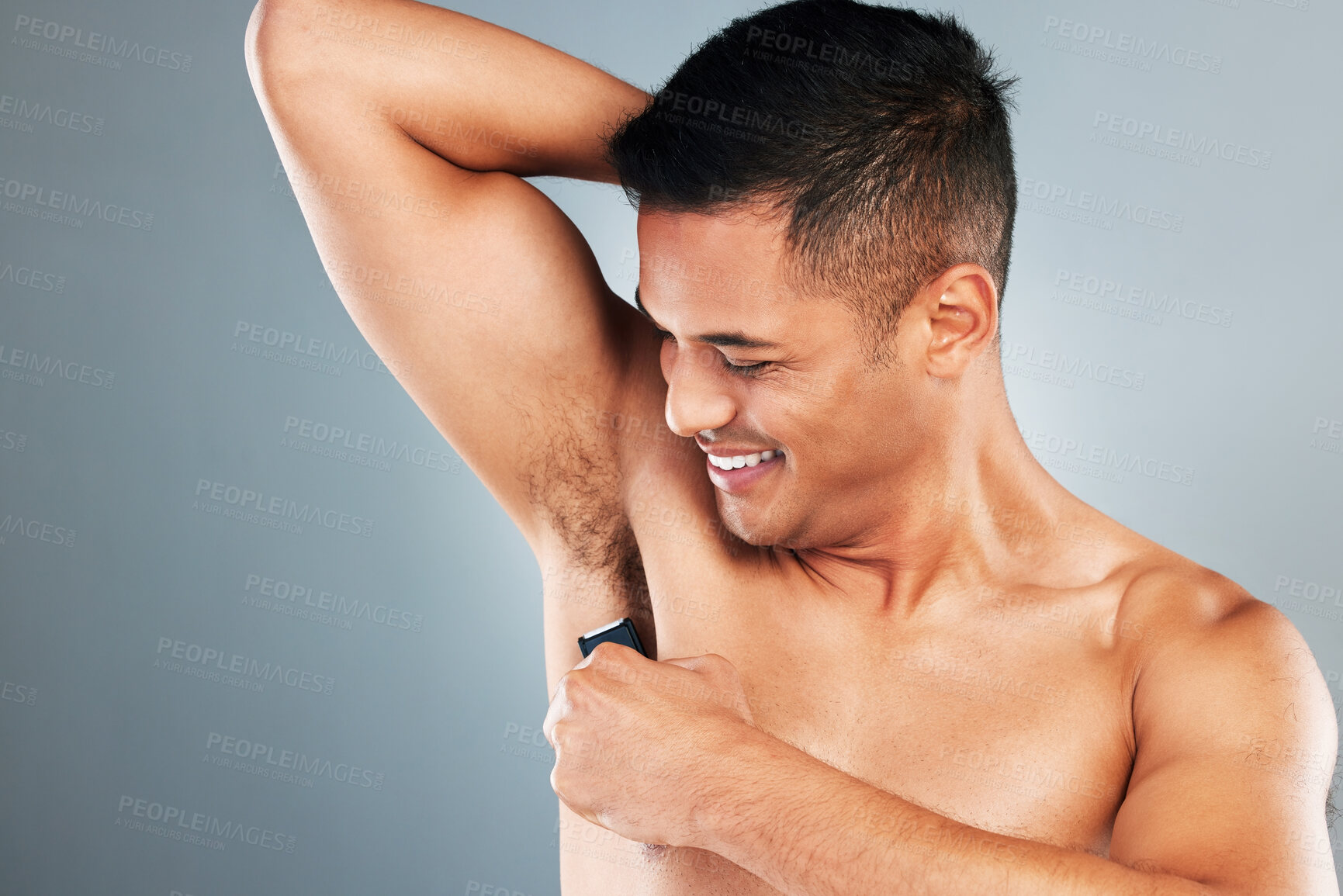 Buy stock photo Man, electric shaving and armpit hair removal for skincare, clean body health and aesthetic wellness cosmetics on grey studio background. Happy guy grooming underarm, razor trimmer and fresh hygiene