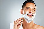 Skincare, facial and man shaving beard or face hair for cleaning cream and razor. Happy latino male shave, handsome and taking care of skin during morning routine for beauty and hygiene wellness 
