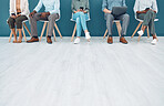 Business people, legs and job interview wait on technology in studio, startup company or digital marketing office. Men, women and workers line in human resources, global recruitment or hr tech review