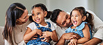 Love, care and parents with happy family of children laughing together at home in Puerto Rico. Mama, father and daughter siblings bonding in house with cheerful affection and excited smile.

