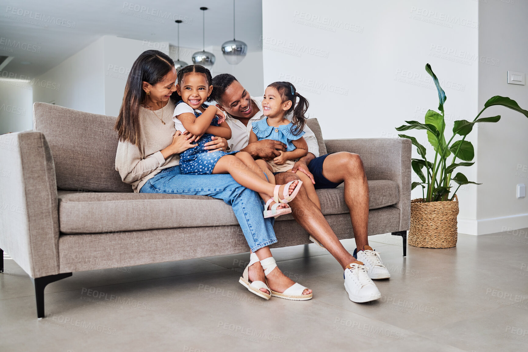 Buy stock photo Family, children and laugh with a girl, sister and parents sitting on a sofa in the home living room together. Kids, laugh and humor with a mother, father and daughter siblings bonding in a house