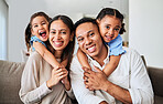 Love, happy family and sofa bonding in a living room with cheerful, fun and loving people. Family, portrait and kids embracing cheerful parents, enjoying relaxing, quality time indoors in their home