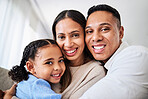 Family, happy and face portrait in living room home, smiling and bonding. Love, care and happy parents, child or girl hugging, embrace or spending quality time together in house with smile or support