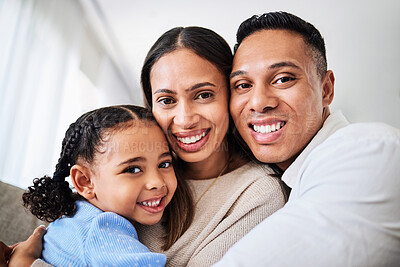 Buy stock photo Family, happy and face portrait in living room home, smiling and bonding. Love, care and happy parents, child or girl hugging, embrace or spending quality time together in house with smile or support