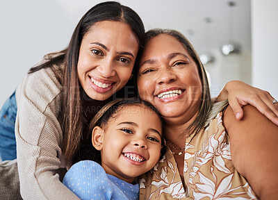 Buy stock photo Love, family and portrait of multigenerational women on a sofa, relax, happy and bonding in a living room. Portrait, mother, girl and grandma smile, hug and relaxing on a couch enjoying quality time