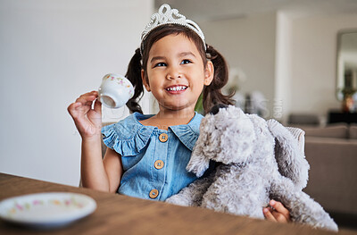 Buy stock photo Children, imagination and tea party with a girl playing pretend at a table in her home alone. Kids, happy and game with a young female child drinking from a cup with a teddy bear in her house