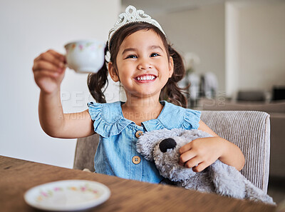 Buy stock photo Tea party, happy girl and happiness of a young child on a home kitchen table with a smile. Play, fun and Asian kid from China with a tiara at a house smiling and playing with a cup and teddy bear