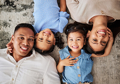 Buy stock photo Happy family, love and portrait on floor by kids and parents bonding in living room from above. Face, family and girls smile, relax, and bond with mother and father, laughing and having fun on carpet