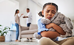 Sad, girl and teddy hug of a child crying from a parents fight and divorce in a home living room. Depressed kid, problem and youth anxiety of children depression from mama and dad family fighting 