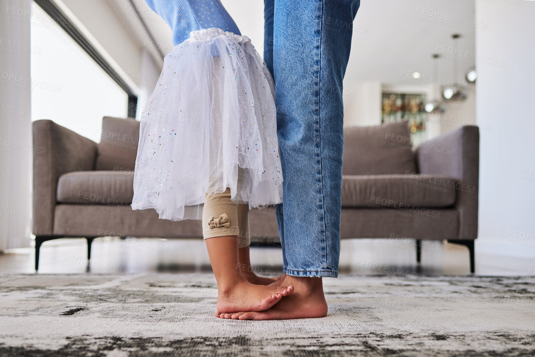 Buy stock photo Feet, child and mother teaching a dance ballet movement on the living room floor together in their house. Legs of a girl kid learning and dancing to music with her mom in the lounge of their home