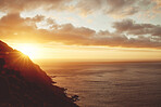 Sunset, sea and clouds with a view of the beautiful ocean or horizon during summer outdoor. Water, nature and sunrise with a picturesque scene of the earth, mountain or cloudy skin outside in the day