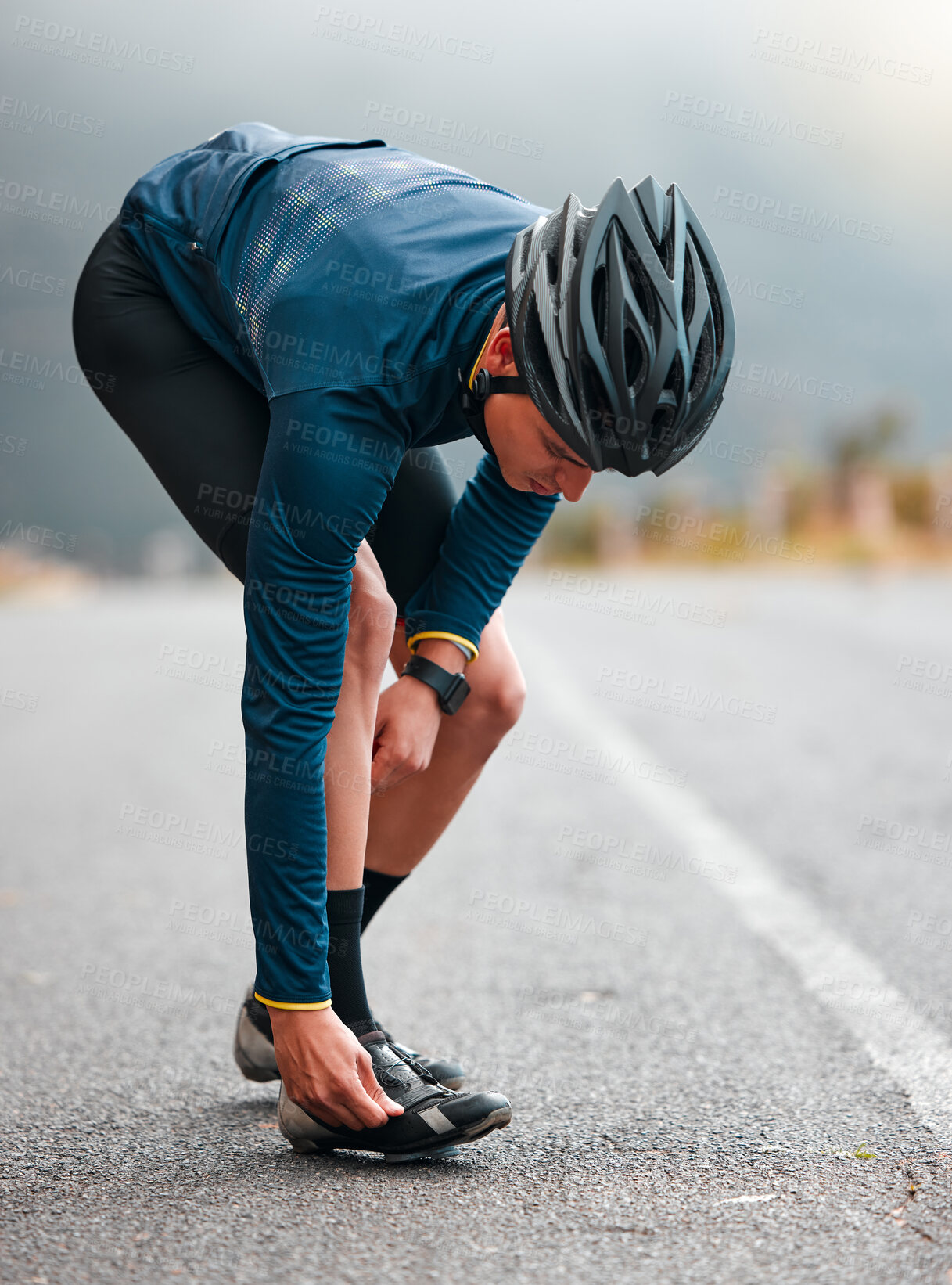 Buy stock photo Cycling, man and shoes preparation on road for outdoor sports adventure, triathlon or workout. Fitness, training and athlete cyclist man on street with helmet getting ready for cycle exercise.

