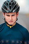 Cycling, helmet and serious with a sports man outside, ready to ride or cycle for exercise and fitness. Workout, training and cardio with a male athlete riding with focus for health or endurance