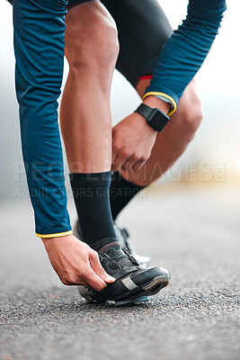 Road, cycling shoes and man cyclist on a fitness trip for a marathon in the city for training. Sports, exercise and male athlete on outdoor cycle for a cardio workout in the street of an urban town.