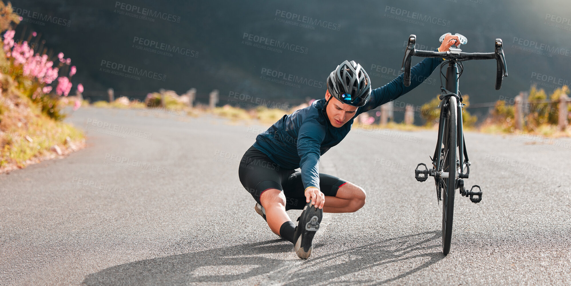 Buy stock photo Cycling, stretching and street with a sports man stopping on an asphalt road for a stretch during a ride. Bicycle, helmet and prepare with a male athlete outdoor for bike fitness or exercise