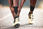 Foot, pain and man in the road for fitness, cardio or exercise with a medical emergency in the city. Feet, legs and athlete runner training for sports in the road with an injury from a workout or run