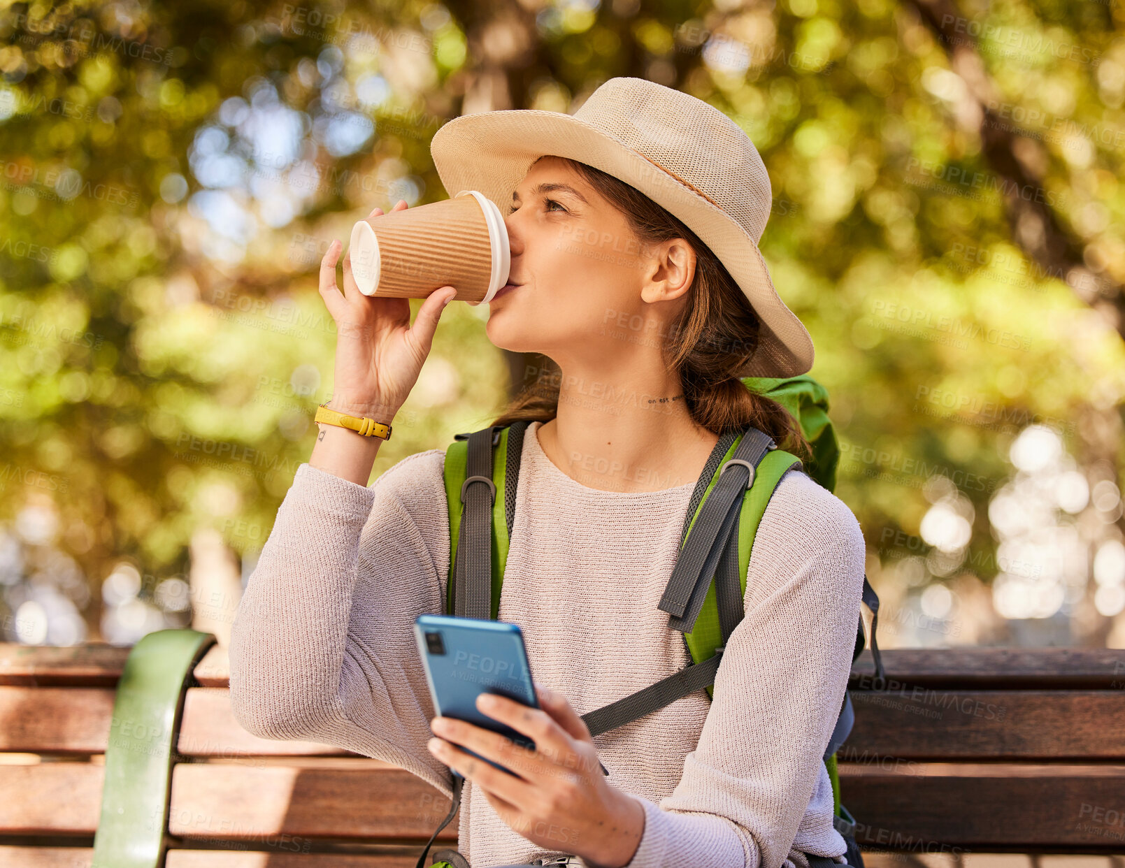 Buy stock photo Woman, phone and coffee in relax for backpacking on park bench for nature adventure in the outdoors. Female hiker or explorer relaxing on smartphone and drinking beverage with 5G connection for GPS 