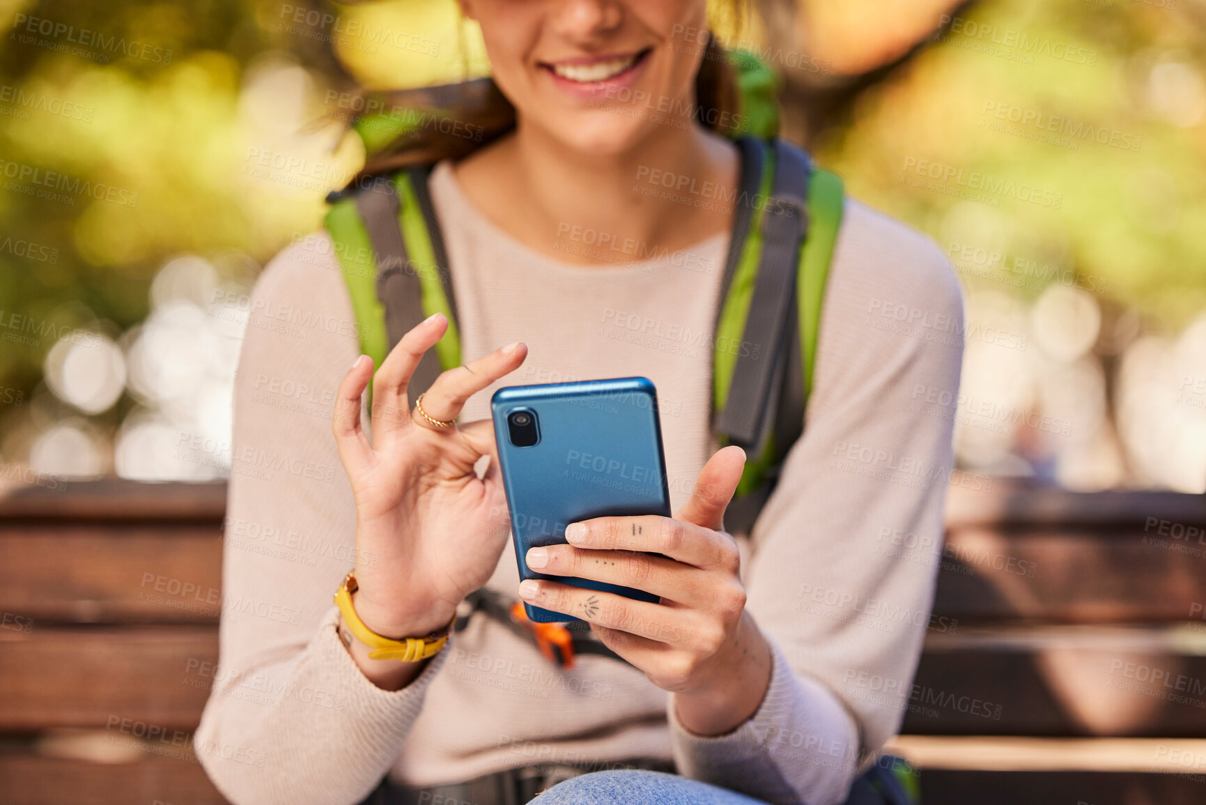 Buy stock photo Phone, hands and hiking woman relax outdoors check hike trail online using 5g tech internet device. Young girl smile, search travel direction or type social media smartphone communication in nature