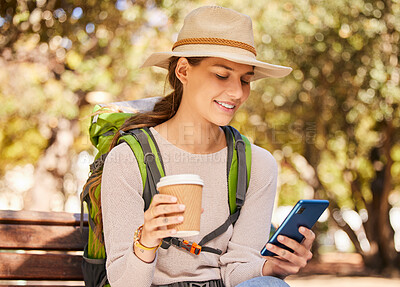 Buy stock photo Phone, coffee and travel with a woman backpacker using 5g mobile technology for directions or navigation in a park. Social media, tourism and communication with a young woman typing a text message