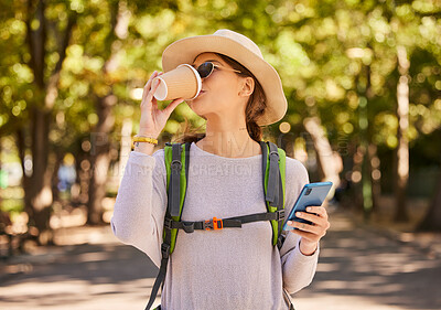 Buy stock photo Backpack, nature and woman with phone and coffee in hand, walking in park. Travel, tourist and girl hiking on summer day to explore and adventure. Freedom, travelling and lady with smartphone in city