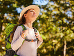 Hiking, travel and woman backpacking in the forest for outdoor wellness, adventure or eco friendly lifestyle. Breathing, trekking and carbon footprint girl with backpack gear in woods, park and trees