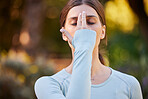 Fitness, meditation and woman with hand on face for calm pressure relief and mindfulness in nature. Yoga, mindset and zen girl preparation for workout with mental tension technique for wellness.