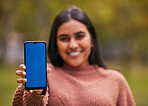 Green screen, girl and hands with phone portrait for online alert, notification or communication. Marketing, internet and app advertising Indian woman in nature with mobile mock up in foreground.

