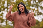 Park, relax and young student with peace sign in nature, enjoying freedom, holiday and vacation. Summer, happiness and smile portrait of Indian woman outdoor for fun, peace and free time on weekend