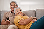 Happy senior couple, love and relax together on living room sofa at family home. Elderly married man and woman, chill and watch tv on couch bonding, laughing and smile at comic joke or movie