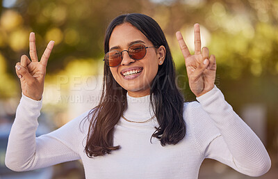 Buy stock photo Peace sign, black woman and sunglasses with smile, being confident and proud outdoor for summer vacation, relax and being edgy. Portrait, girl and female being trendy, show hand sign and have fun.