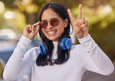 Buy stock photo Music, headphones and peace hand sign of a woman from mexico in nature on a walk. Portrait of a person with a happy smile, sunglasses and gesture streaming audio outdoor feeling free in a nature park