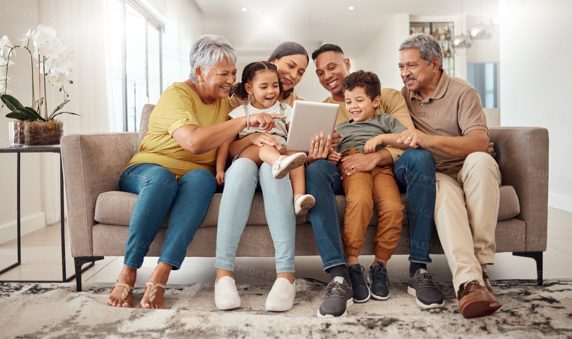 Buy stock photo Family, children and tablet on home sofa for elearning, online education and digital teaching software website. Happy grandparents, mom and dad or women and men help kids with ebook or internet game
