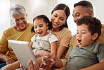 Happy, family and online entertainment on tablet enjoying technology and bonding time together on living room sofa. Parents, grandma and kids relaxing on couch streaming on touchscreen at home