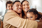 Love, family and hug portrait in living room with Mexican parents and young kids in house. Care and happy latino man, woman and children enjoy cuddle together for care and appreciation in home