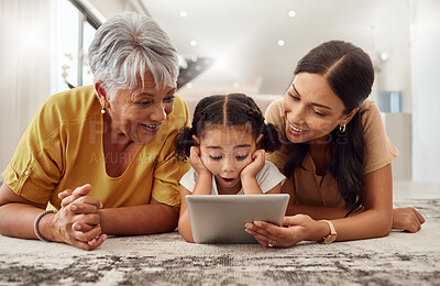 Buy stock photo Grandmother, mother and child with a tablet streaming a movie while relaxing together. Shocked, surprised and happy family watching a online video on social media with digital  device in a home