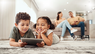 Buy stock photo Learning, tablet and children streaming a video on technology on the living room floor of their house. Education, happiness and movies on technology for kids with parents on the sofa in their home